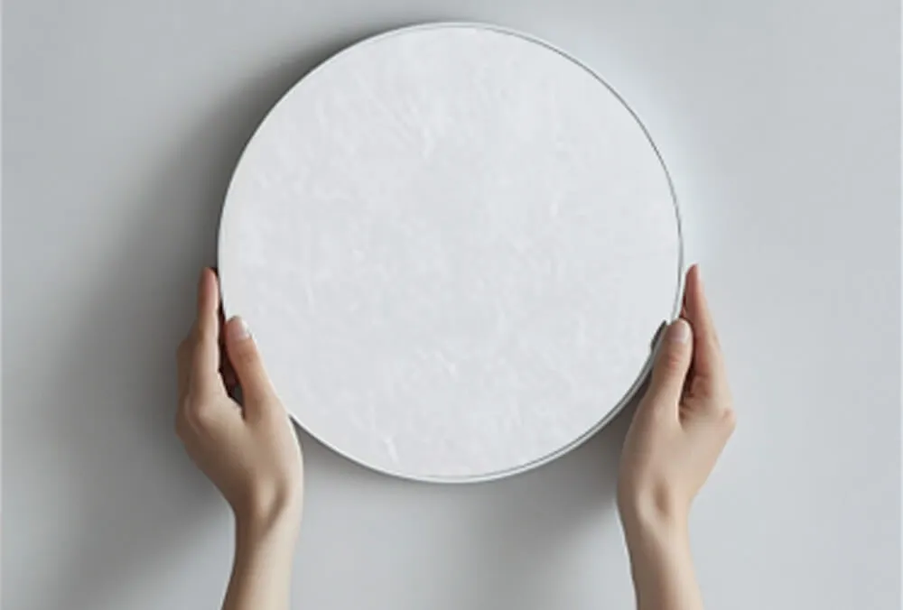 Circular Acrylic Mirror Sheet Installation Pressing a circular acrylic mirror sheet onto the wall